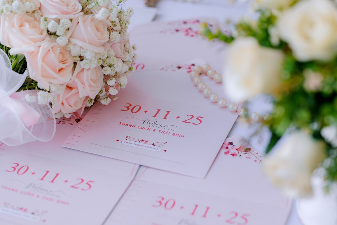 Beautiful wedding invitations surrounded by soft floral arrangements, ready for a romantic celebration.